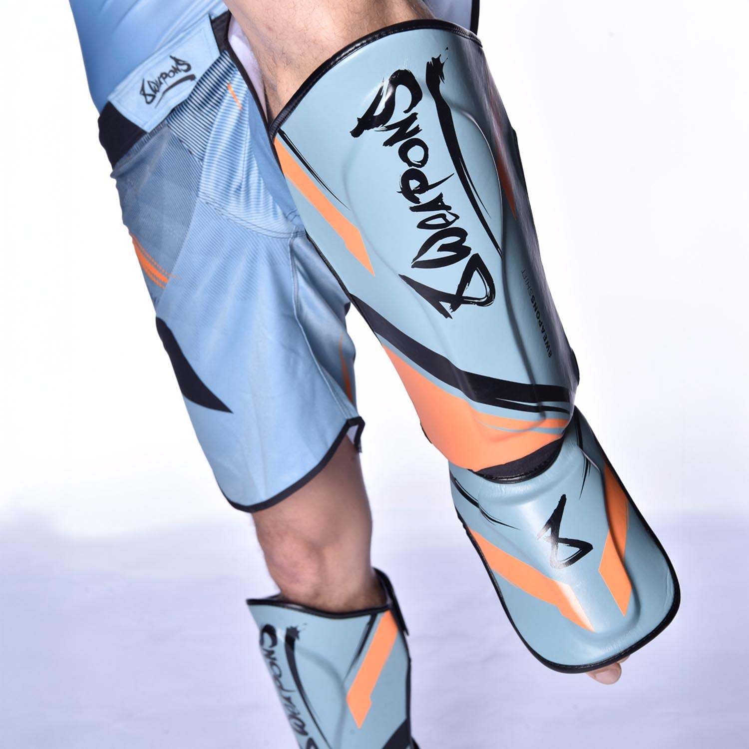 Protège-tibias 8 WEAPONS Shift gris glacé et orange pour sports pieds-poings