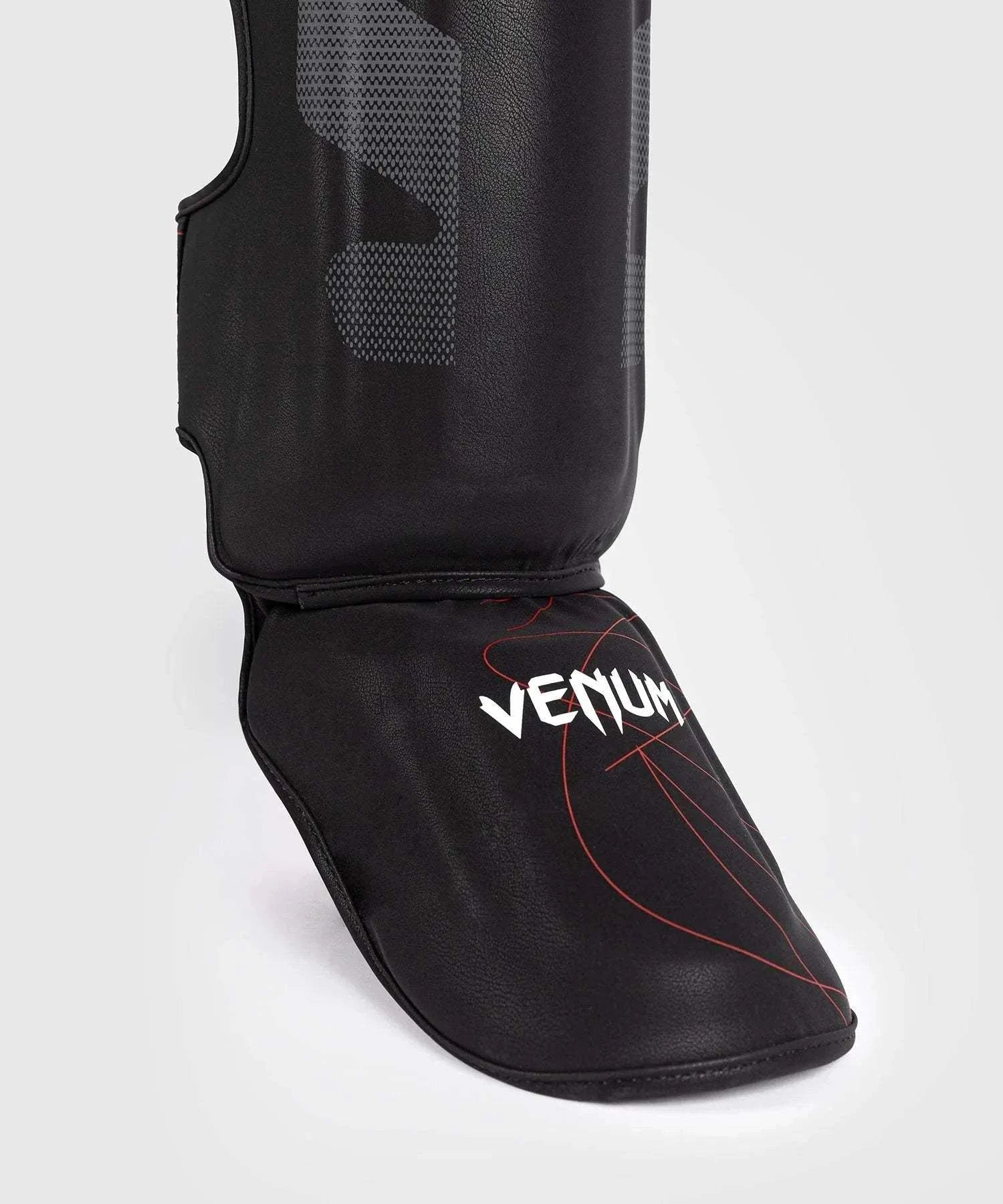 Black and red Venum Tactical XT shin and foot guards with multi-density foam and Velcro straps for MMA and boxing protection